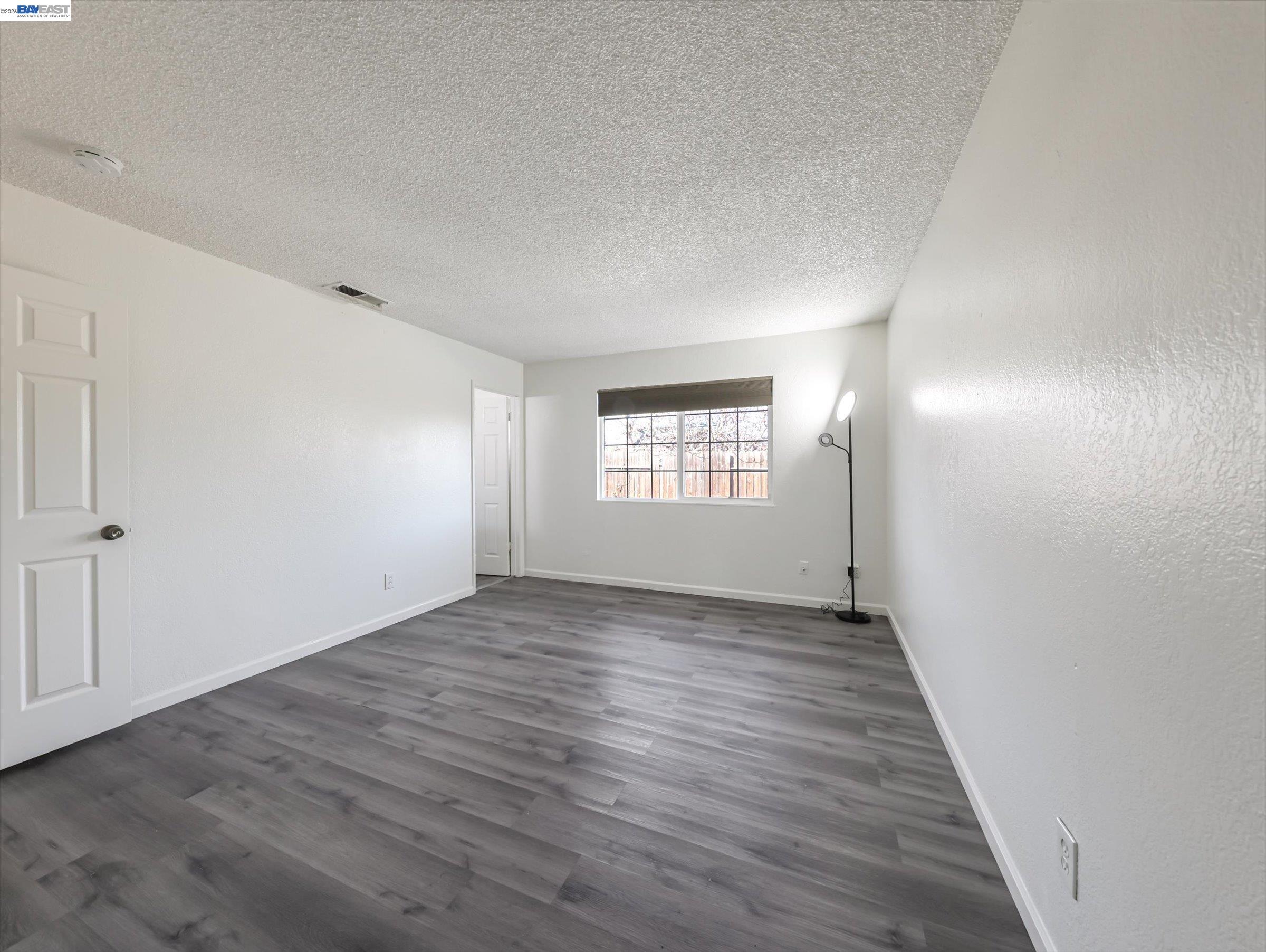 3432 Danielle Place Bay Point, CA 94565 - Photo 22 of 36 an empty room with wooden floor and windows