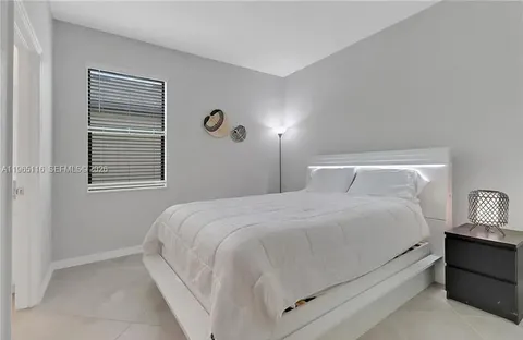a bedroom with a bed and a night stand