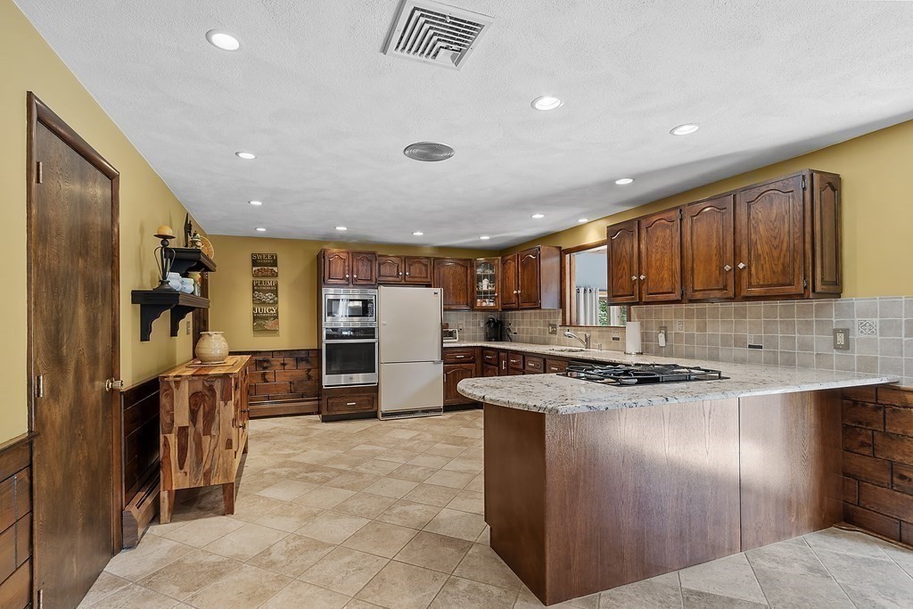 14 Shawmut Avenue Danvers, MA 01923 - Photo 15 of 40 a kitchen with stainless steel appliances granite countertop a refrigerator and a sink