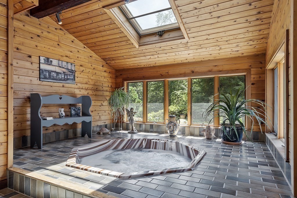 14 Shawmut Avenue Danvers, MA 01923 - Photo 22 of 40 a view of a patio with table and chairs potted plants and floor to ceiling window