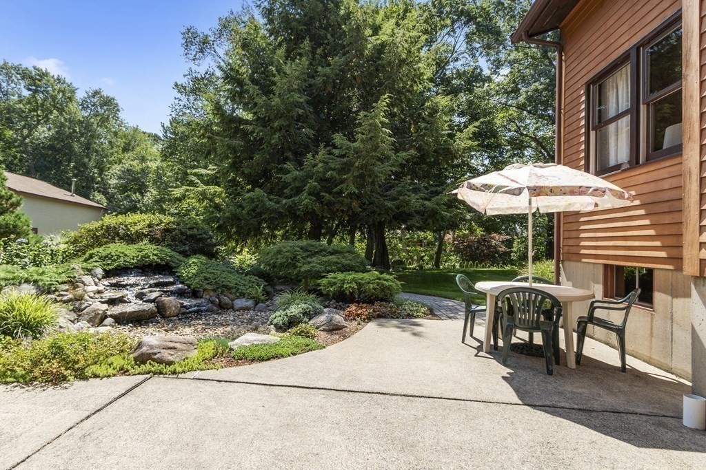 14 Shawmut Avenue Danvers, MA 01923 - Photo 30 of 40 a view of a patio with a table and chairs under an umbrella