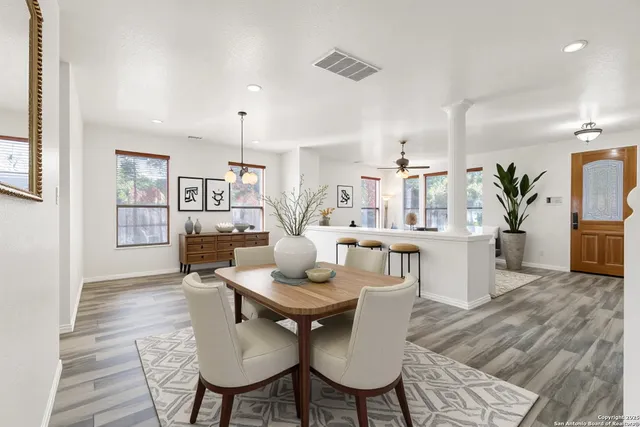 a dining room with furniture and wooden floor