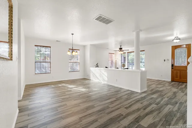 a view of a kitchen with kitchen island wooden floor and window