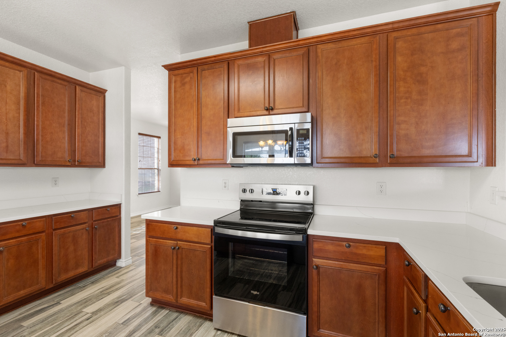 11101 Baywave Live Oak, TX 78233 - Photo 15 of 38 a kitchen with stainless steel appliances granite countertop wooden cabinets a stove and a sink