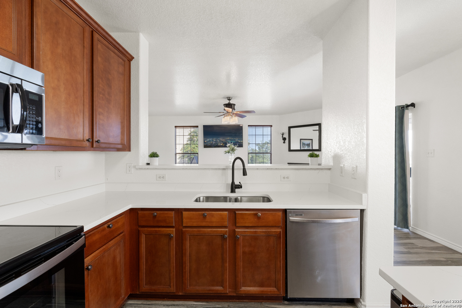11101 Baywave Live Oak, TX 78233 - Photo 16 of 38 a kitchen with stainless steel appliances granite countertop a sink and cabinets