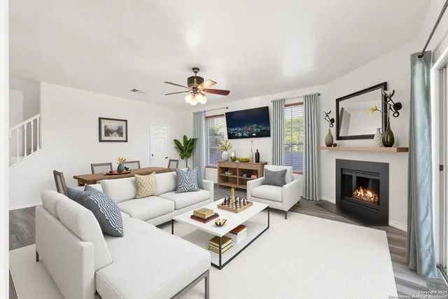 a living room with furniture a fireplace and a flat screen tv