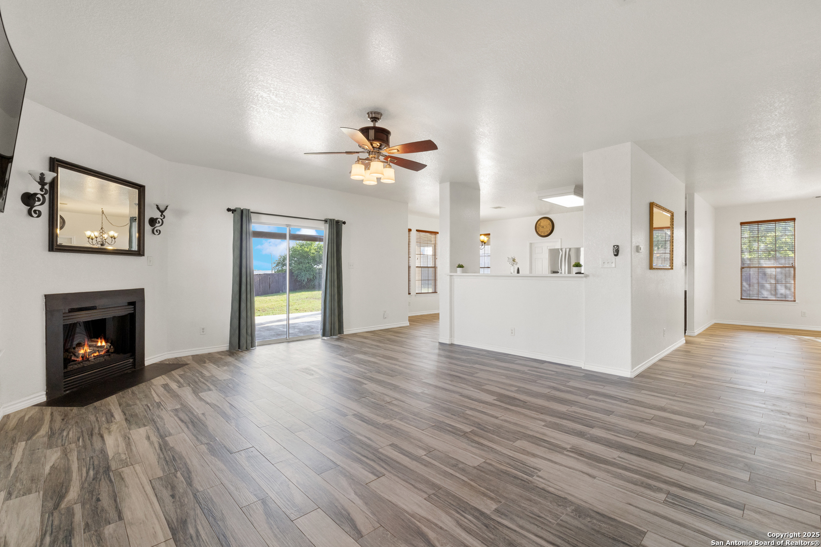 11101 Baywave Live Oak, TX 78233 - Photo 23 of 38 a view of an empty room with window and wooden floor