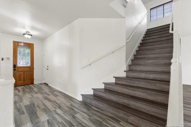 a view of an entryway with wooden floor