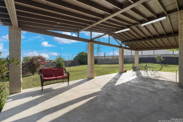 a view of a porch with furniture and a backyard
