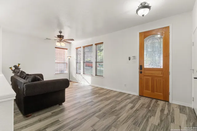 a living room with furniture and wooden floor