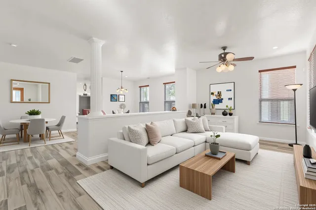 a living room with furniture and a wooden floor