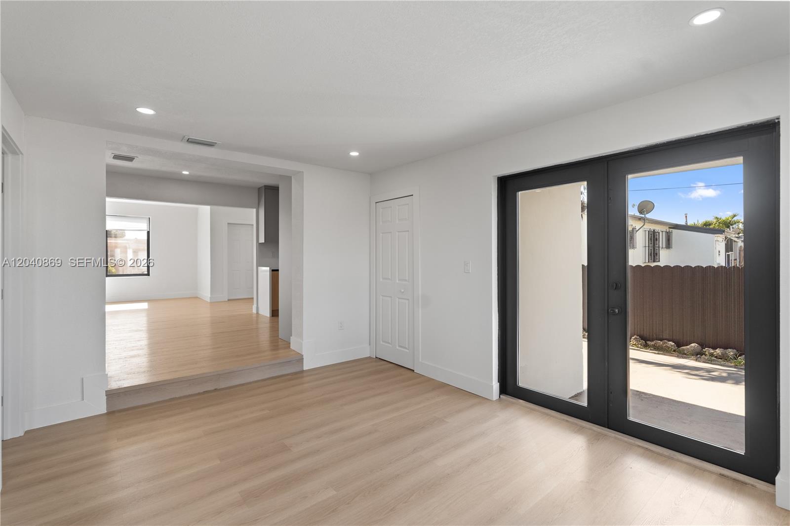 31 West 64th Street Hialeah, FL 33012 - Photo 26 of 49 an empty room with wooden floor and windows