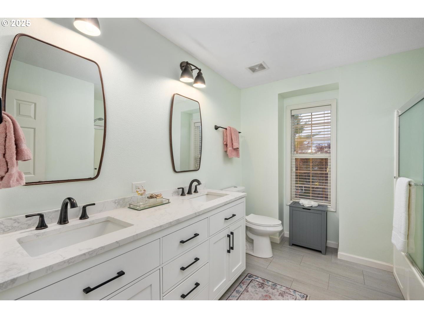 1626 Northwest Caitlin Terrace Portland, OR 97229 - Photo 27 of 48 a bathroom with a double vanity sink toilet mirror and bathtub