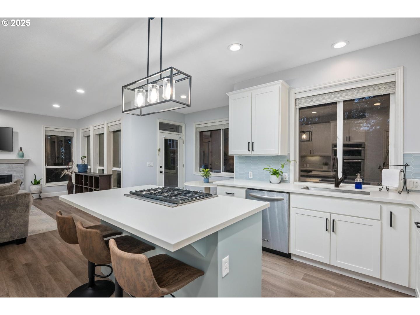 1626 Northwest Caitlin Terrace Portland, OR 97229 - Photo 6 of 48 a kitchen with stainless steel appliances a stove a sink dishwasher and white cabinets with wooden floor