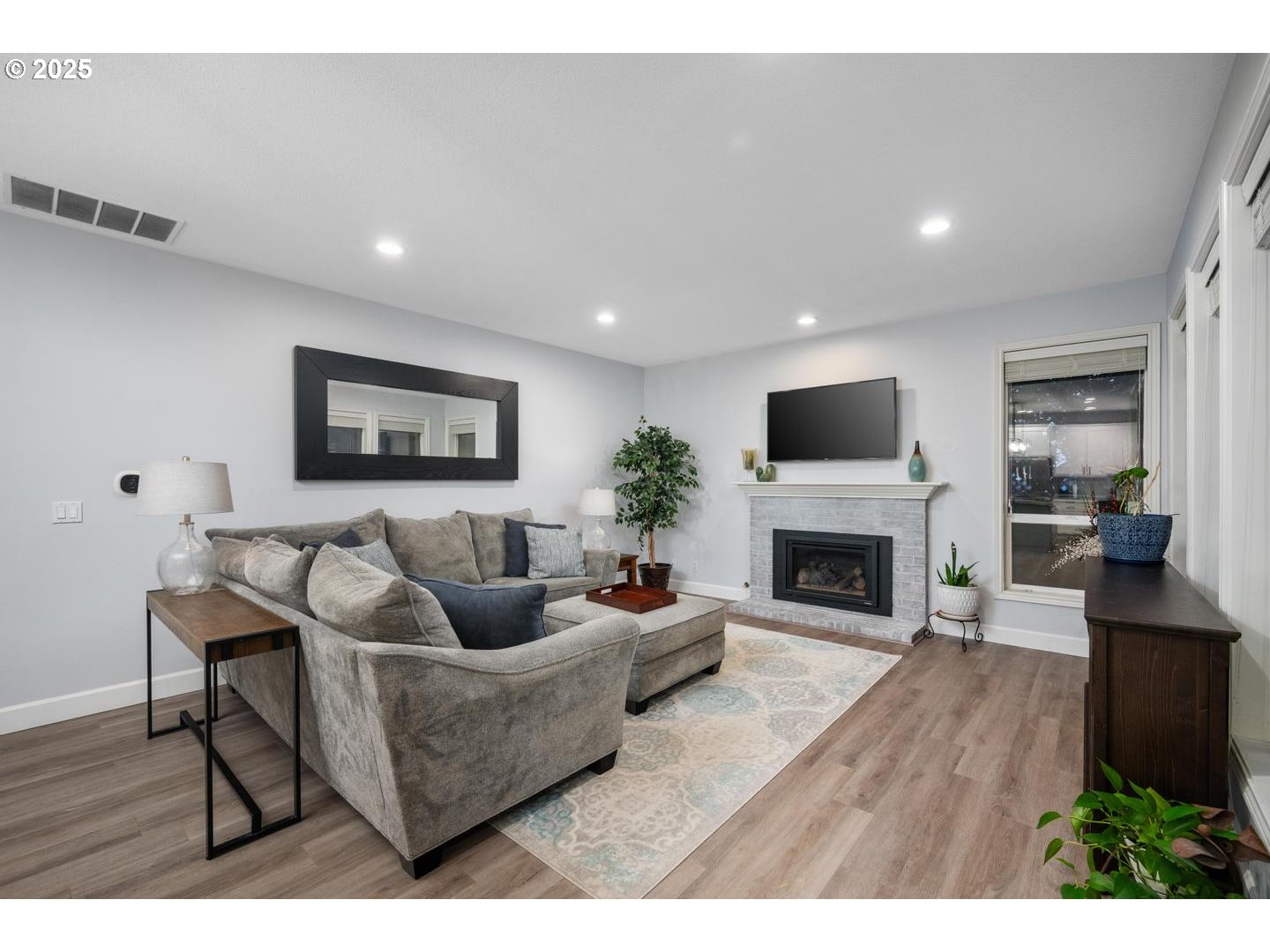 1626 Northwest Caitlin Terrace Portland, OR 97229 - Photo 10 of 48 a living room with furniture a fireplace and a flat screen tv
