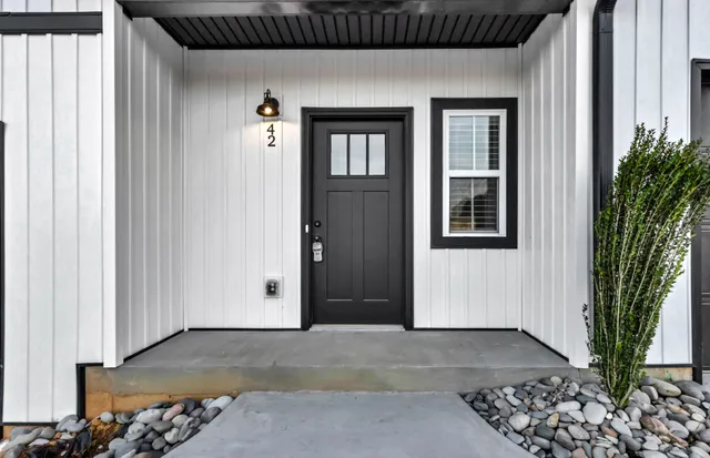 a view of a livingroom with entryway and wooden floor