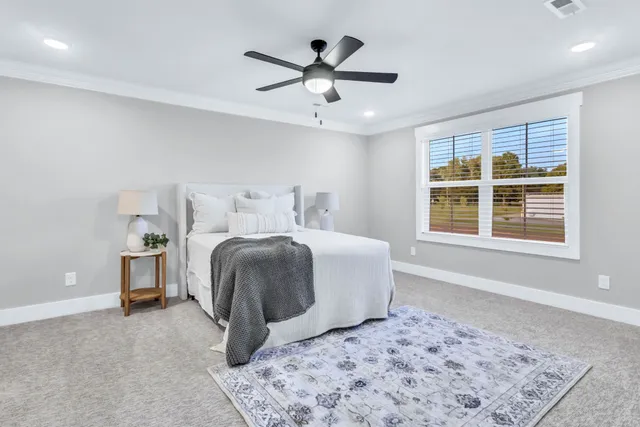 a bedroom with a large bed and a window