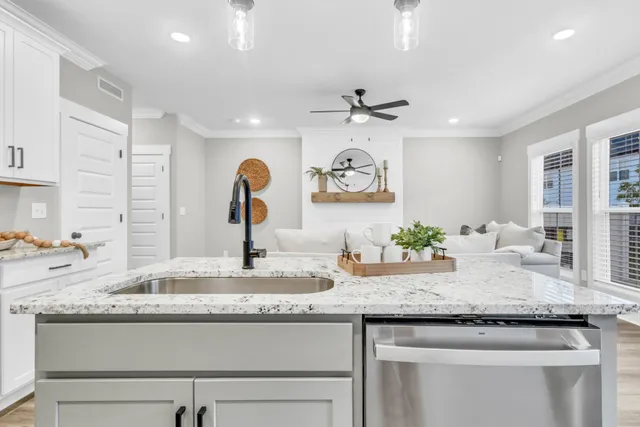 a kitchen with granite countertop a sink stainless steel appliances and a counter top space