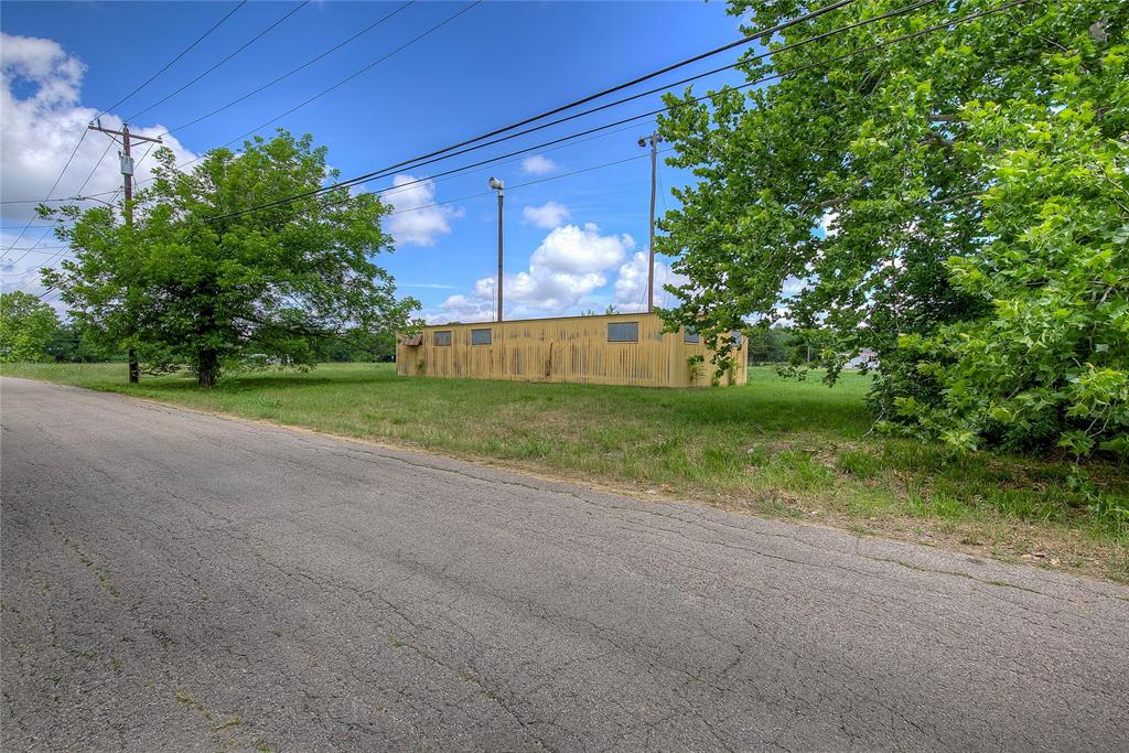 414 North Neal Street Commerce, TX 75428 - Photo 6 of 13 a view of a yard with potted plants and large trees