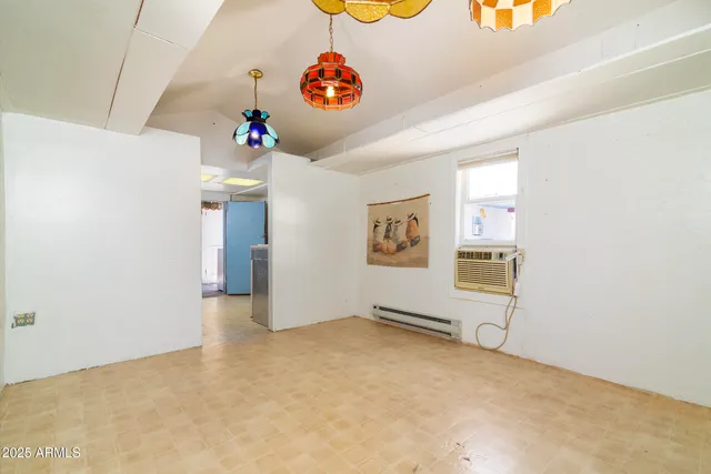 an empty room with bags and window