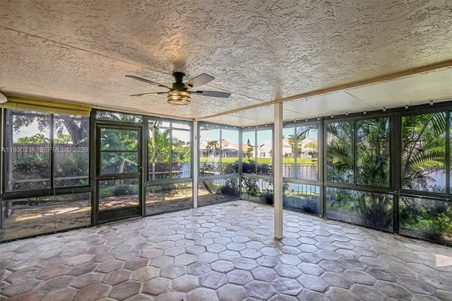 a view of a porch with furniture and floor to ceiling window