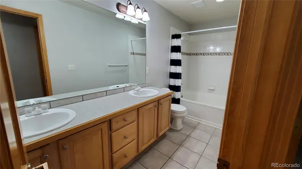 a bathroom with a sink a toilet a shower and a mirror
