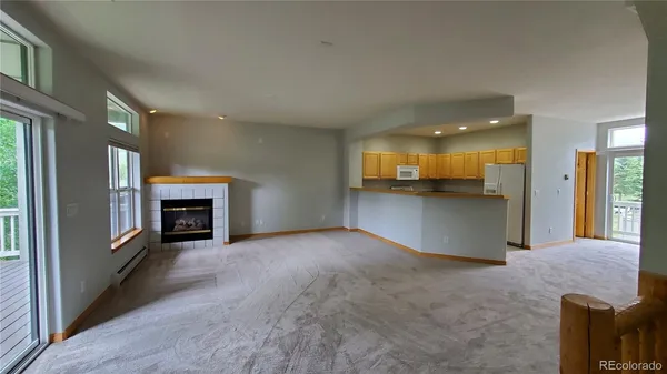 a view of an empty room with a fireplace
