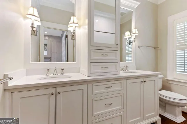a view of a room with wooden floors and chandelier