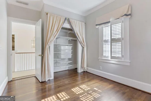 a large bedroom with a large bed and a large window