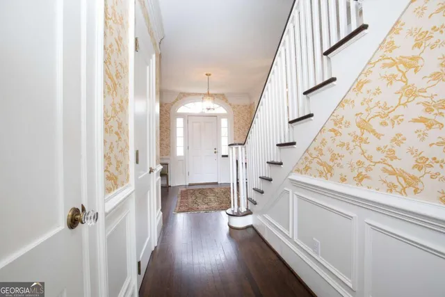 a view of a patio with a table and chairs and potted plants