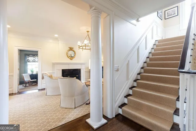 a living room with furniture a chandelier and a window