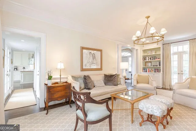 a living room with furniture and a bookshelf