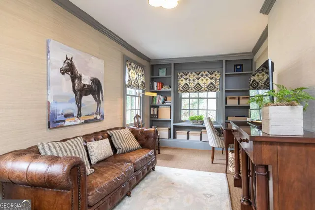 a living room with furniture a fireplace and a large window