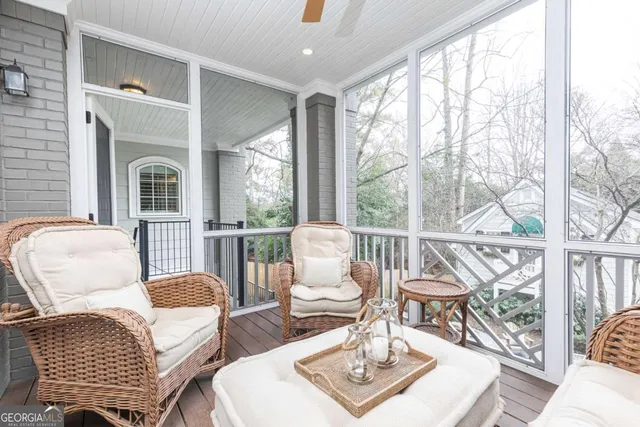 a kitchen with white cabinets and a window