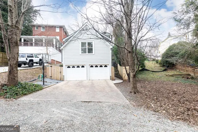 a spacious bedroom with a bed and a chandelier