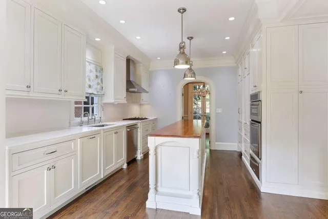 a view of bathroom with a sink and mirror