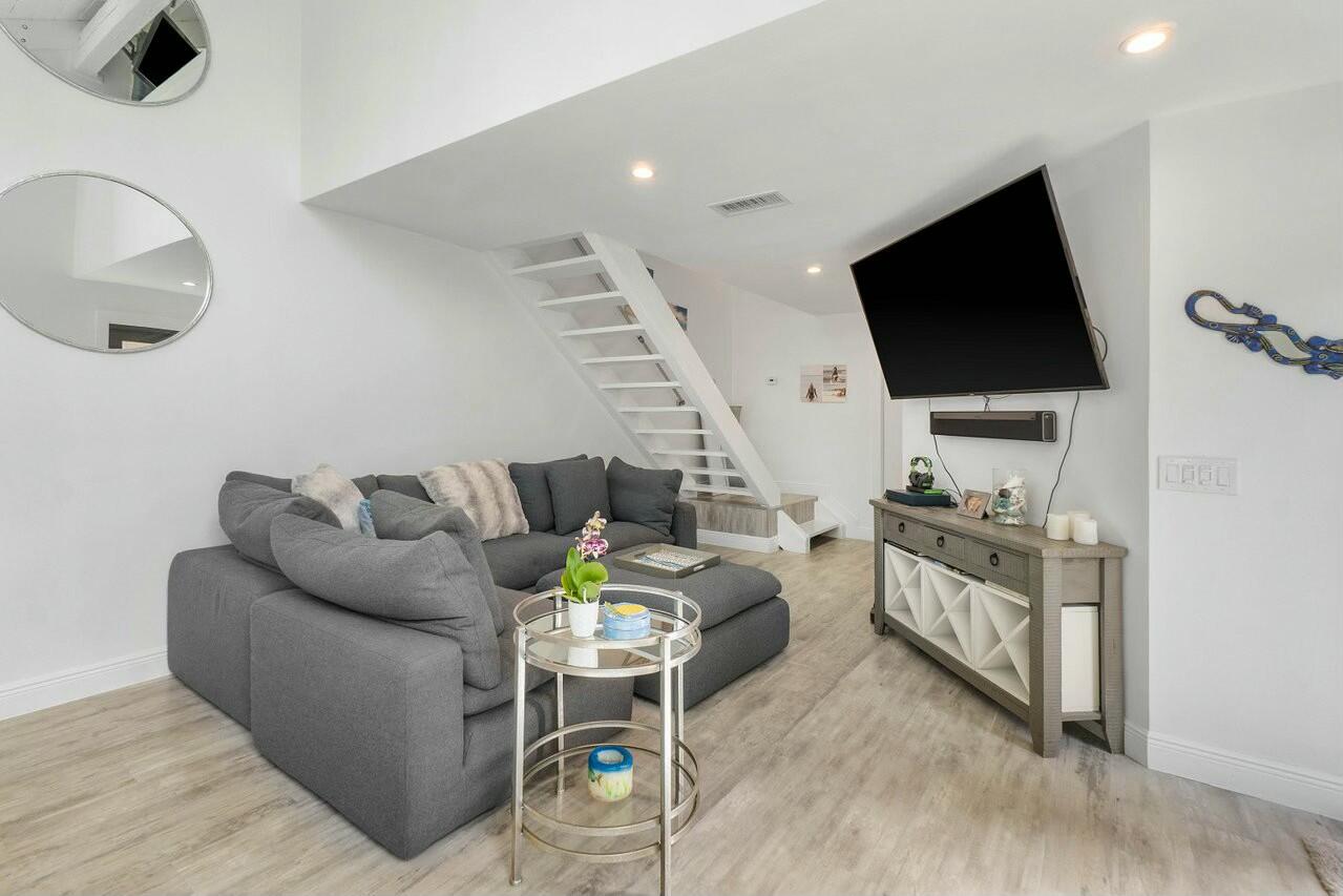 1605 Highway 1, Unit 3H Jupiter, FL 33477 - Photo 3 of 20 a living room with furniture and a flat screen tv