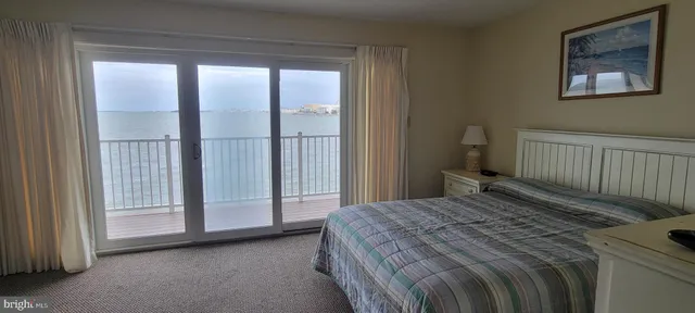 a bedroom with a bed and a white cabinet