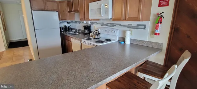 a kitchen with stainless steel appliances granite countertop a refrigerator stove and sink