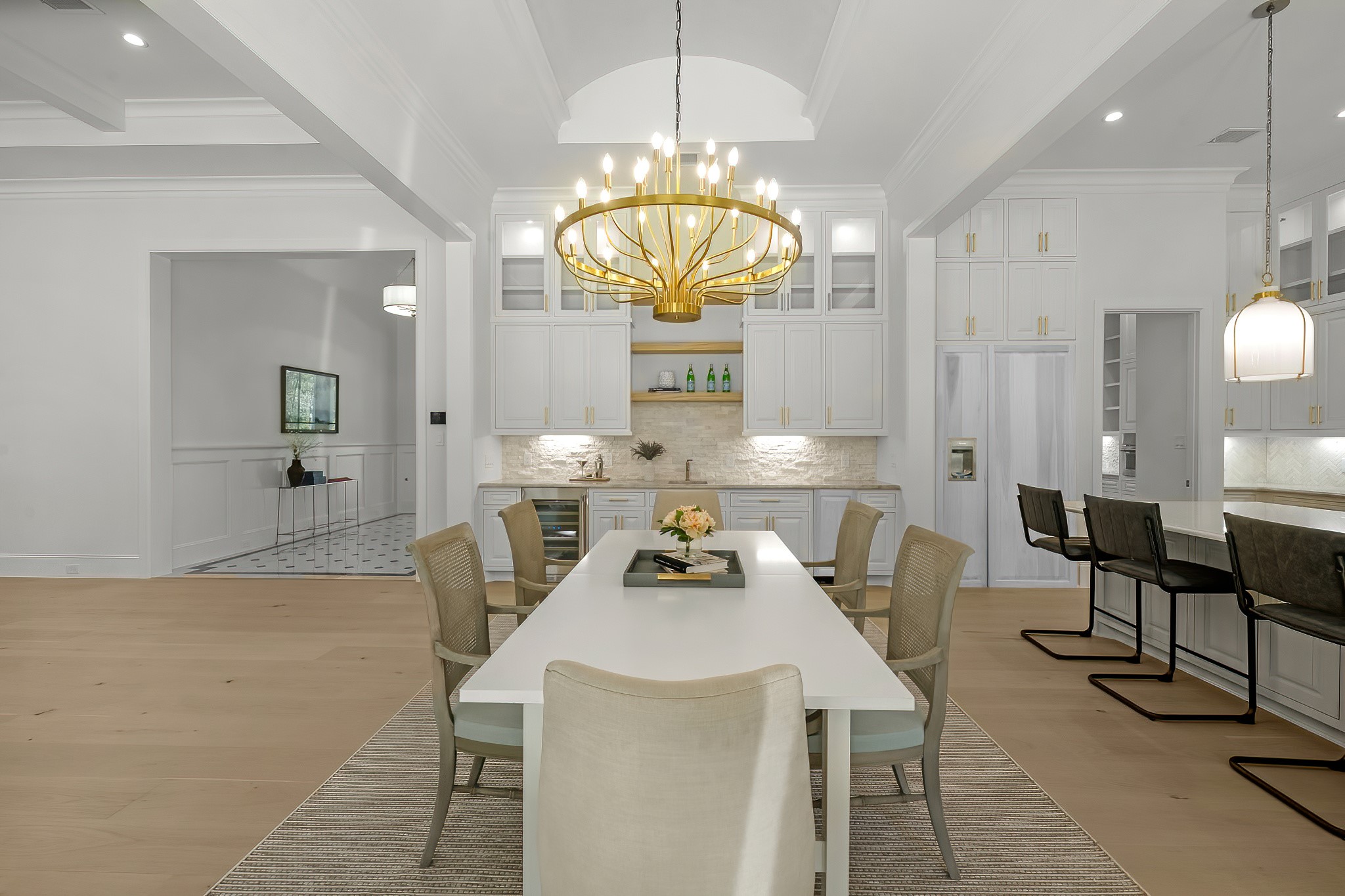 26041 Crown Ranch Boulevard Montgomery, TX 77316 - Photo 14 of 48 a kitchen with a dining table chairs and chandelier