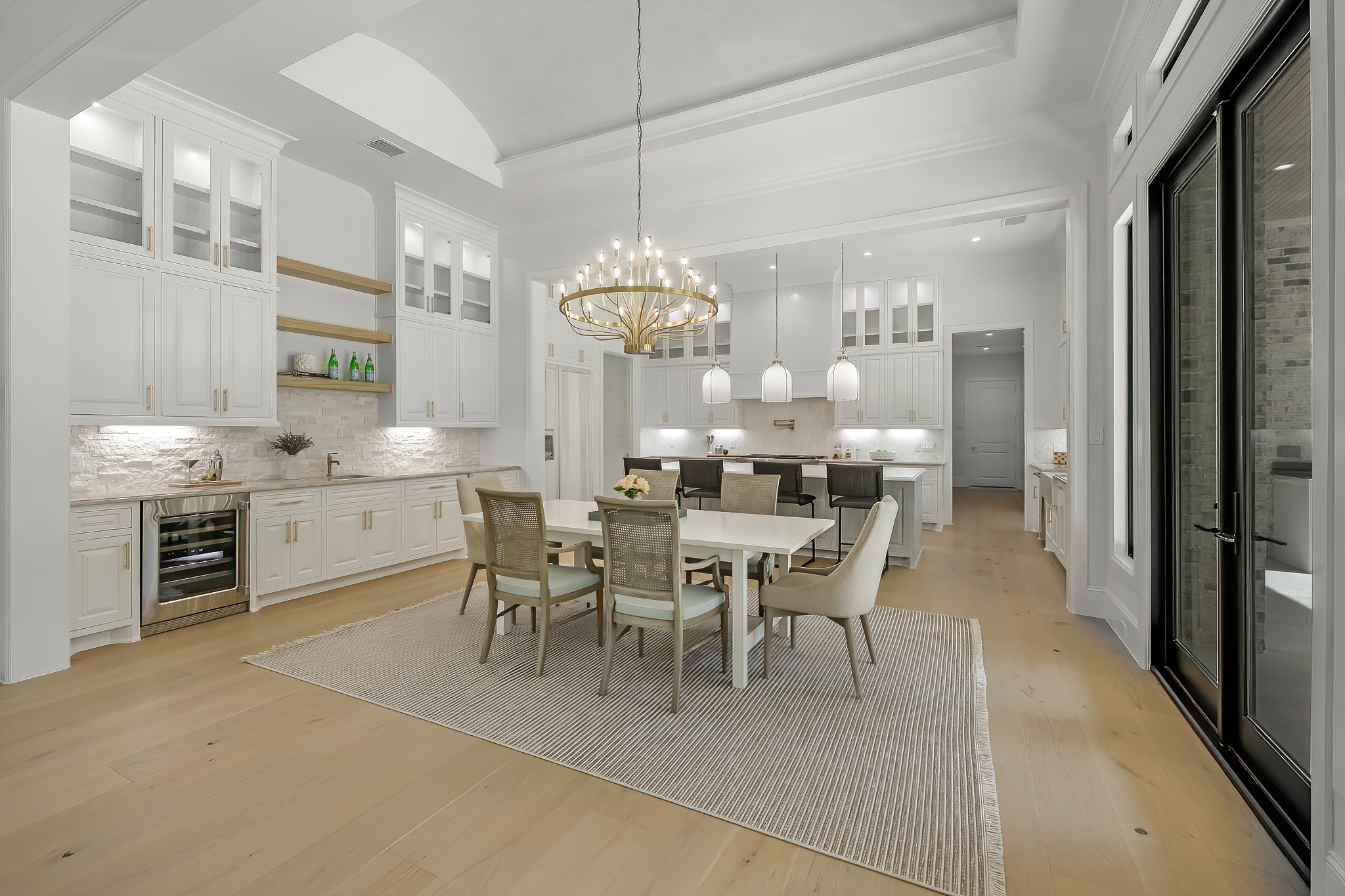 26041 Crown Ranch Boulevard Montgomery, TX 77316 - Photo 15 of 48 a dining room with stainless steel appliances kitchen island granite countertop a table chairs and a refrigerator