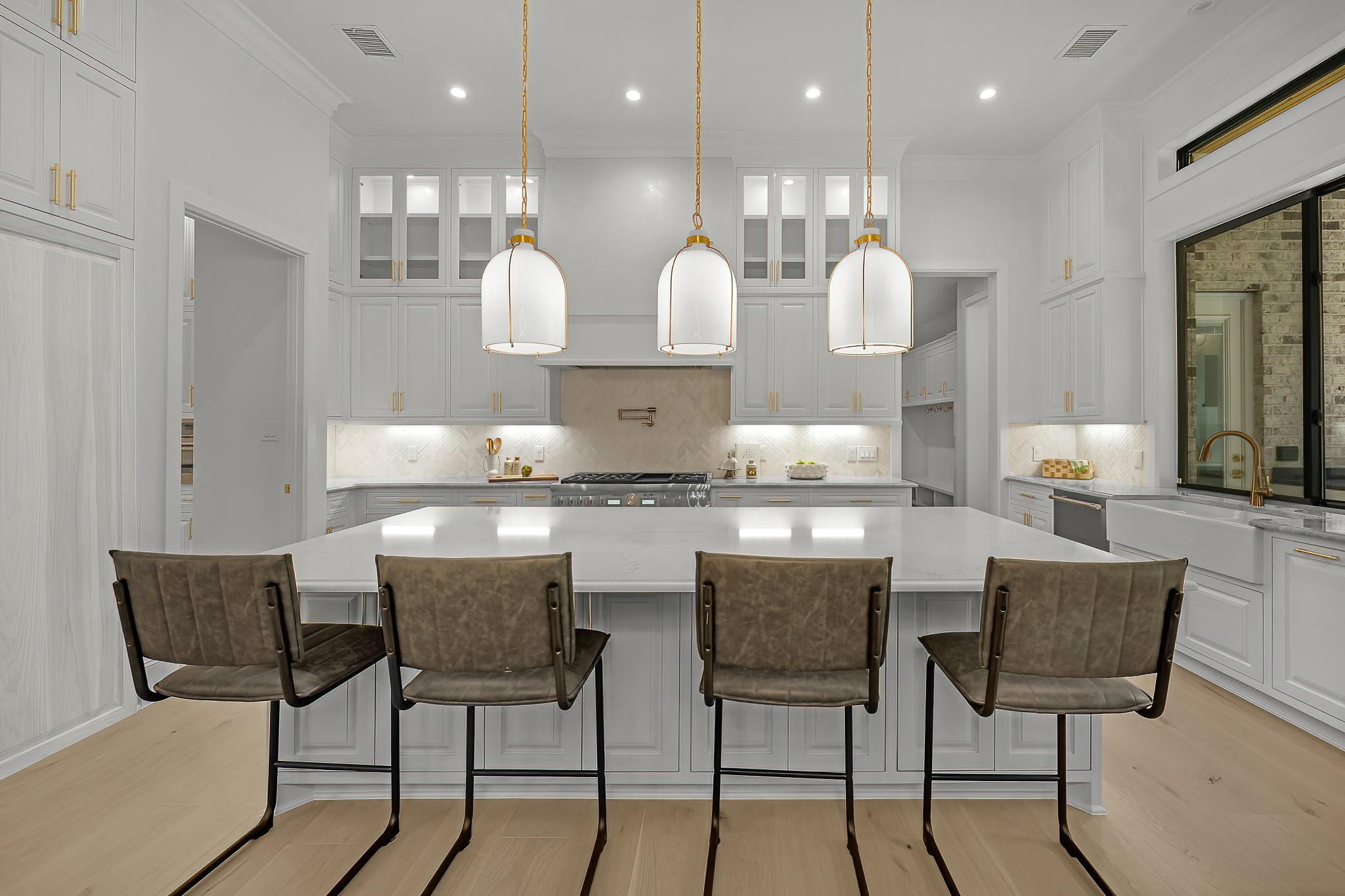 26041 Crown Ranch Boulevard Montgomery, TX 77316 - Photo 18 of 48 a kitchen with kitchen island granite countertop wooden cabinets and chairs