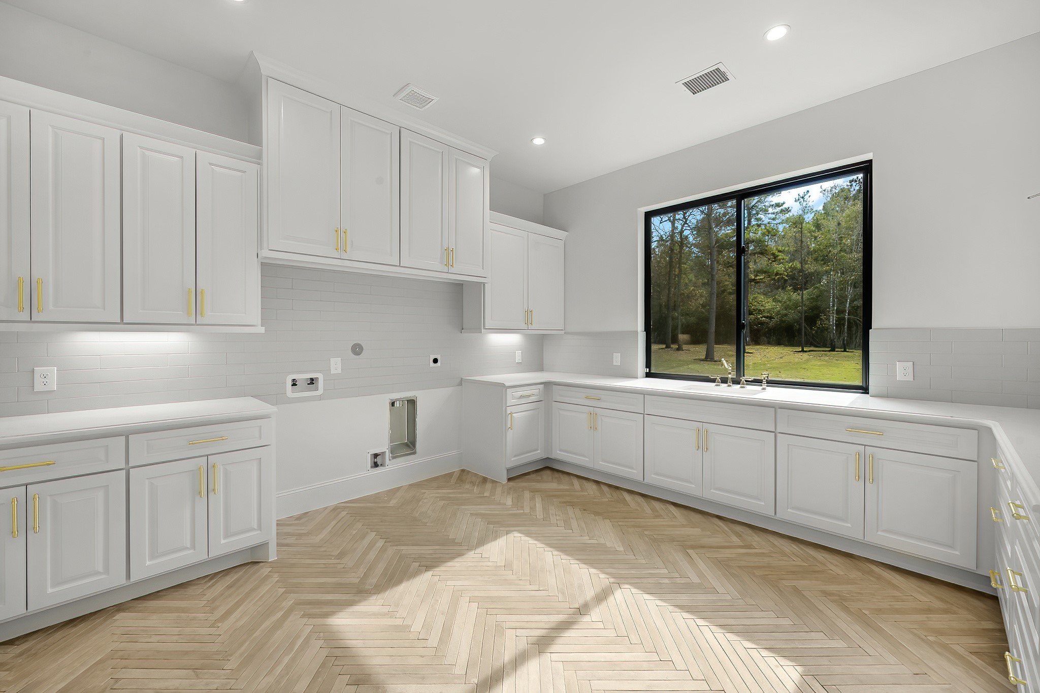26041 Crown Ranch Boulevard Montgomery, TX 77316 - Photo 23 of 48 a kitchen with white cabinets and sink