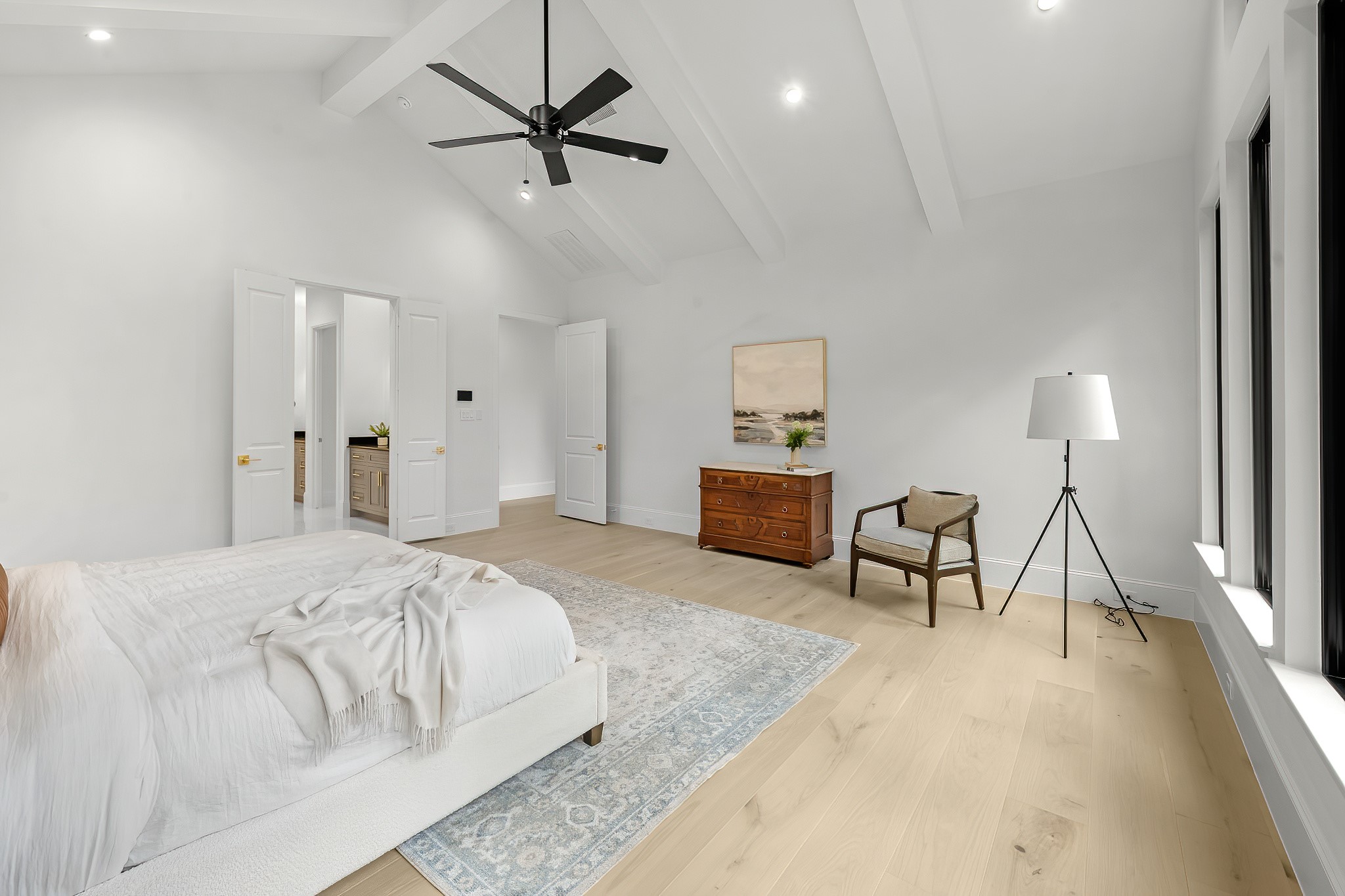 26041 Crown Ranch Boulevard Montgomery, TX 77316 - Photo 37 of 48 a spacious bedroom with a bed a desk and chair