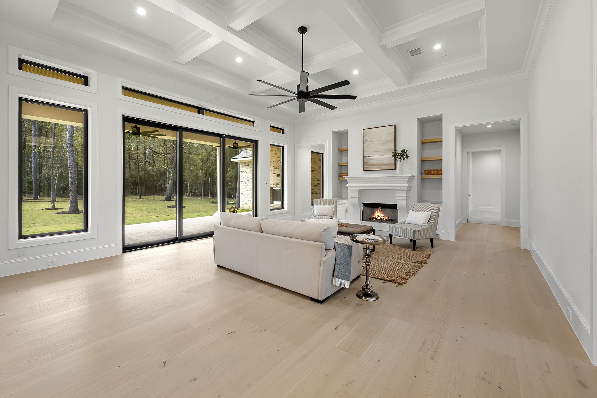 26041 Crown Ranch Boulevard Montgomery, TX 77316 - Photo 9 of 48 a living room with furniture a fireplace and a chandelier