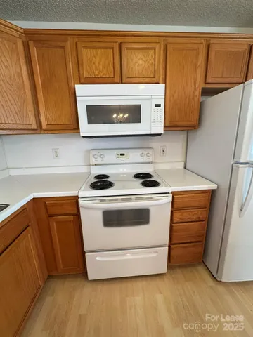 a kitchen with stainless steel appliances granite countertop a stove a microwave and a refrigerator