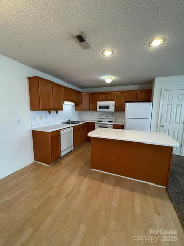 a kitchen with stainless steel appliances a refrigerator and a microwave