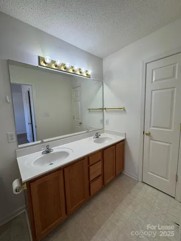 a bathroom with a double vanity sink and a mirror