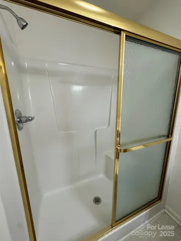 a bathroom with a glass door shower and a sink