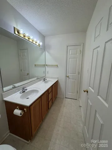 a bathroom with a double vanity sink and mirror